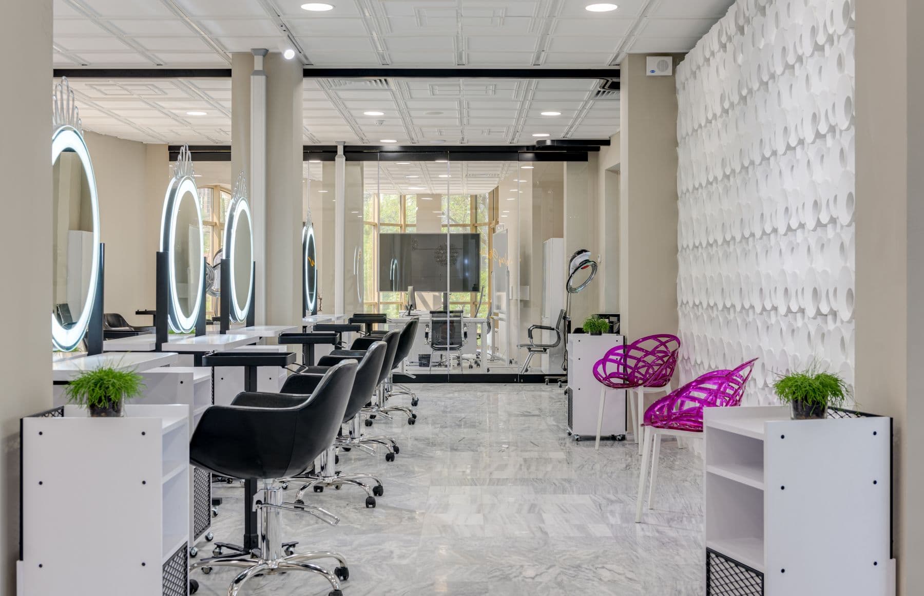 A bright hair salon with chairs and large mirrors